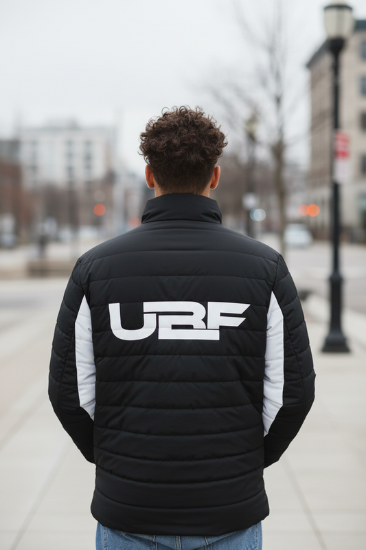Person wearing a black and white jacket with 'URF' logo on the back against a white background