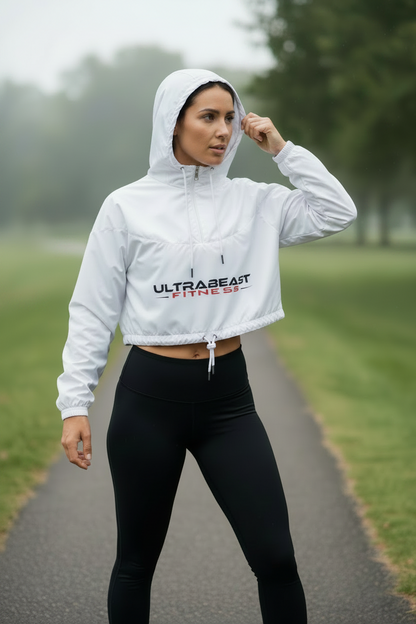 Person wearing a white hoodie with 'ULTRABEAST FITNESS' branding in a park setting.